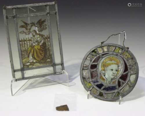 A leaded and stained glass circular panel, painted with a portrait of St Stephen, diameter 20cm,