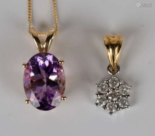 A 9ct gold pendant, claw set with an oval cut amethyst, length 2cm, an 18ct gold neckchain, detailed