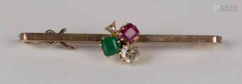 A gold, diamond, ruby and emerald bar brooch, the centre with a trefoil motif on a plain bar,