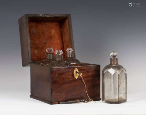 A George III mahogany decanter box, fitted with four facet cut glass decanters with plated collars