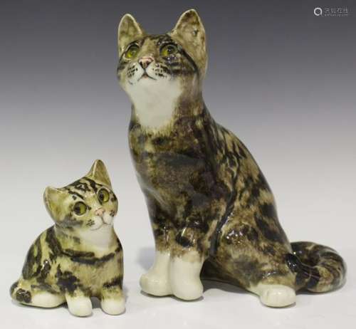 A Winstanley pottery seated tabby cat with inset glass eyes, height 23cm, and a similar smaller