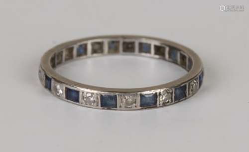 A platinum, diamond and sapphire eternity ring, mounted with circular cut diamonds alternating