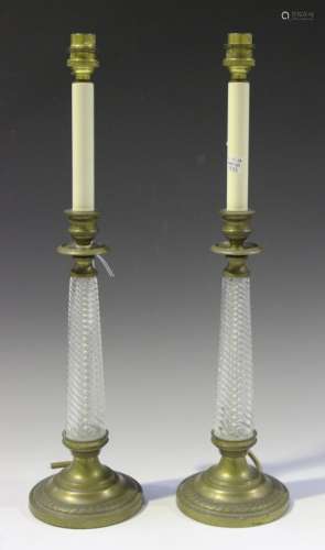 A pair of modern Regency style moulded clear glass and brass mounted table lamps, height 50cm.