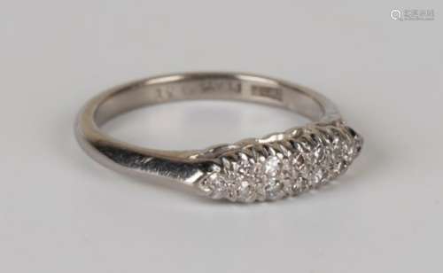A white gold, platinum and diamond ring, mounted with two rows of circular cut diamonds in a boat