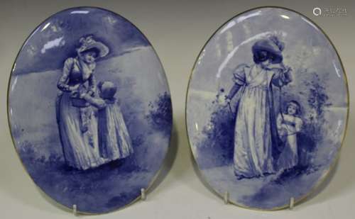 A pair of Royal Doulton Blue Children oval wall plaques, early 20th century, painted with a mother