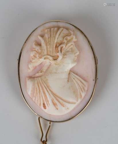 A gold mounted oval pink shell cameo brooch, carved as a portrait of a classical lady, detailed '