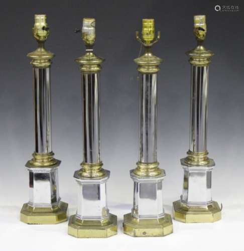 A set of four late 20th century French chromium plated and brass table lamps of column form,