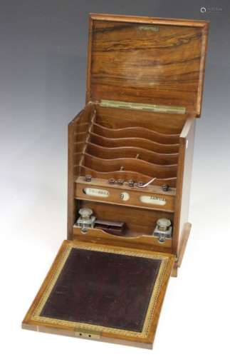 A Victorian walnut stationery cabinet, the hinged lid and fall front revealing a leather writing