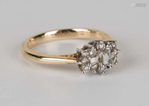 A 9ct gold and diamond ring, mounted with three baguette diamonds within a surround of twelve