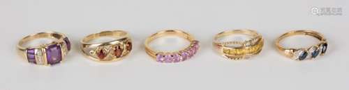 A gold, amethyst and diamond ring detailed '10K', a 9ct gold and garnet set three stone ring, a