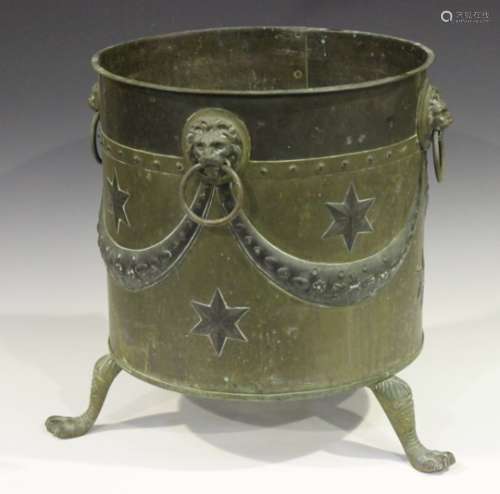 An early 20th century copper and brass coal bin of cylindrical form, the exterior with swag and star
