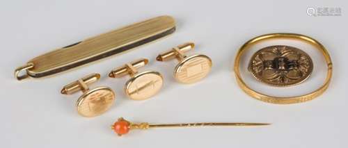 A gold and coral stickpin, the finial designed as a claw, a gold mounted folding fruit knife,