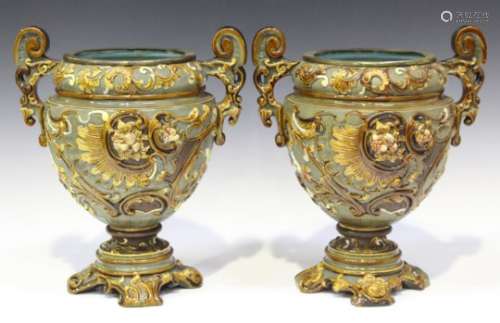 A pair of W. Schiller & Sons majolica oil lamp bases, circa 1900, the U-shaped bodies relief moulded