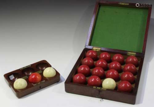 A set of three late 19th century ivory billiard balls, each diameter 5.3cm, within a mahogany