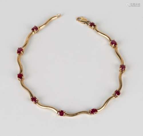 A 9ct gold and ruby bracelet, claw set with oval cut rubies alternating with serpentine links, on