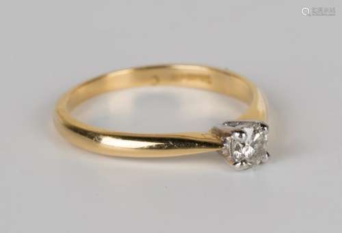 An 18ct gold and diamond single stone ring, claw set with a circular cut diamond, ring size approx