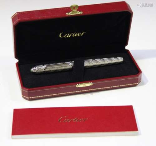 A Cartier silver coloured plated metal cased rollerball pen with a palmette decorated finish and