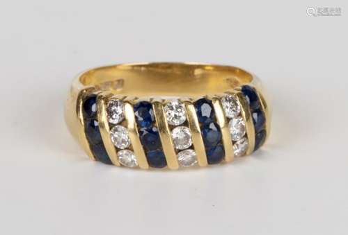 An 18ct gold, sapphire and diamond ring, mounted with four rows of three circular cut sapphires