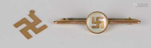 A gold and mother-of-pearl bar brooch, the circular mother-of-pearl centre mounted with a fylfot