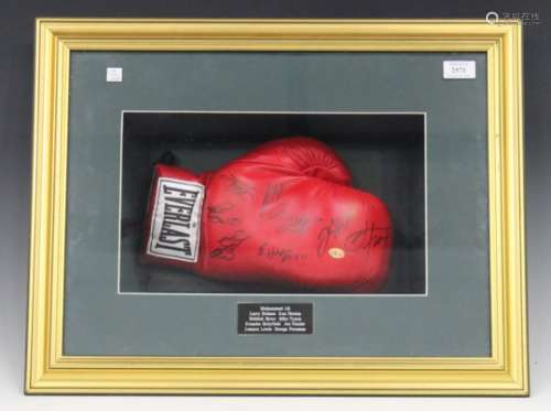 An Everlast red boxing glove, purportedly bearing the signatures of nine heavyweight champions,