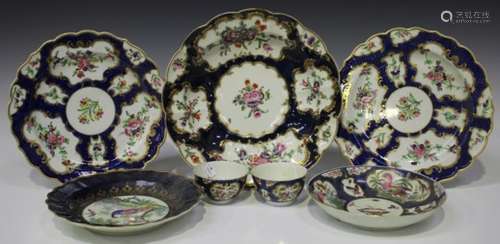 A pair of Worcester porcelain blue scale ground tea bowls, circa 1765-70, painted with gilt edged