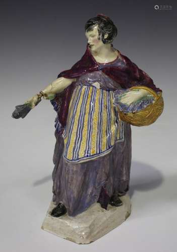 A Charles Vyse pottery figure of The Lavender Girl, circa 1920, modelled standing, holding a