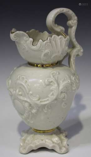 A Belleek porcelain mask jug, circa 1891-1926, with moulded mask to base of handle, second black