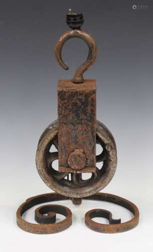A cast and wrought iron table lamp formed from a 19th century pulley, height 46cm.Buyer’s Premium