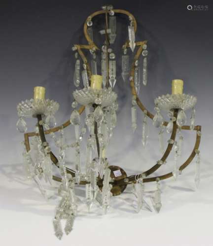 An early 20th century gilt metal and glass three light wall sconce with shaped open wall plate,