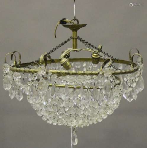 A mid-20th century gilt brass and clear glass circular bag chandelier, the circlet hung with swags