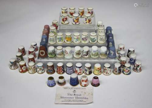 Nine Royal Worcester porcelain thimbles, mid-20th century, each painted with flowers, signed by