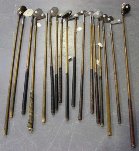 A selection of seventeen hickory shafted golf clubs, including a New Mills Ray Model upright lie
