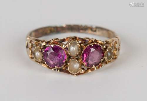 A Victorian gold, half-pearl and mauve paste set ring with scroll decoration to the sides,