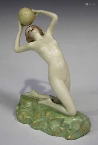 An Art Deco Crown Devon Fieldings figure of a female nude, modelled kneeling and leaning back,