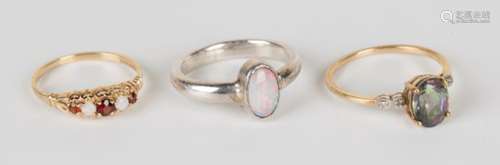 A 9ct gold, garnet and opal five stone ring, a 9ct gold, harlequin topaz and diamond ring and an