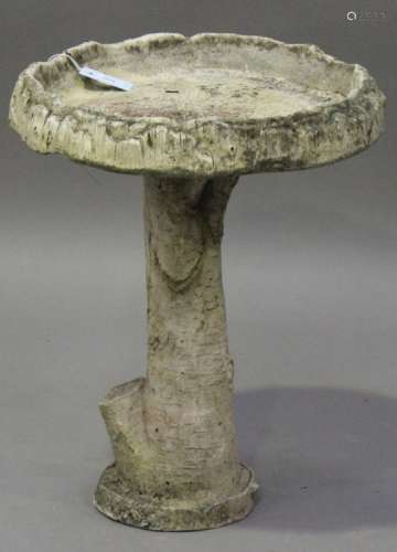 A late 20th century cast composition garden bird bath of naturalistic tree stump form, height