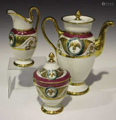 A French porcelain three-piece coffee set, circa 1900 in an earlier style, gilt decorated with