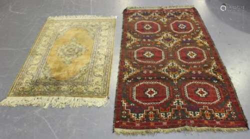 A Turkish part silk rug, mid-20th century, the pale apricot field with a shaped medallion, within