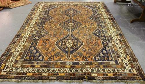 A Shiraz carpet, South-west Persia, early 20th century, the terracotta field with three linked