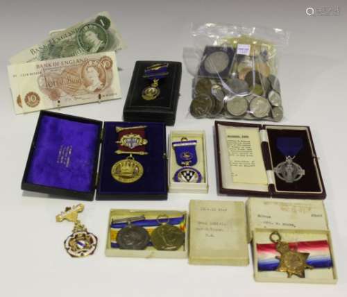 A collection of coins and medals, including a First World War trio to '207414. Cpl. W. Young. R.