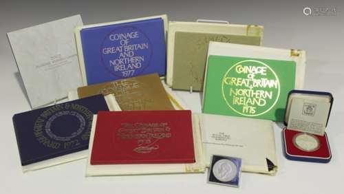 Seven various year-type sets, a silver commemorative crown 1977, cased, a commemorative five