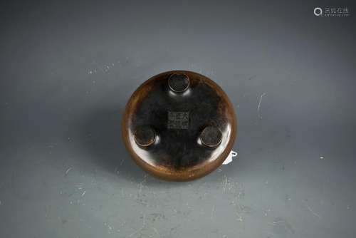 A BRONZE TRIPOD CENSER