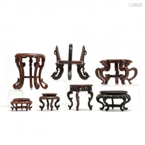 A Group of 7 Chinese Carved Wooden Raised Stands