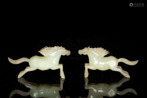 A FINE PAIRE OF CELADON JADE CARVINGS OF HORSES