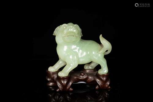 A FINE CELADON JADE CARVING OF A FU LION