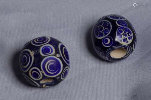 TWO GLASS BEADS WITH STRINGING HOLE