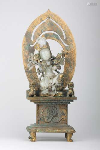 A WHITE JADE BUDDHA WITH GILT-BRONZE MANDORLA