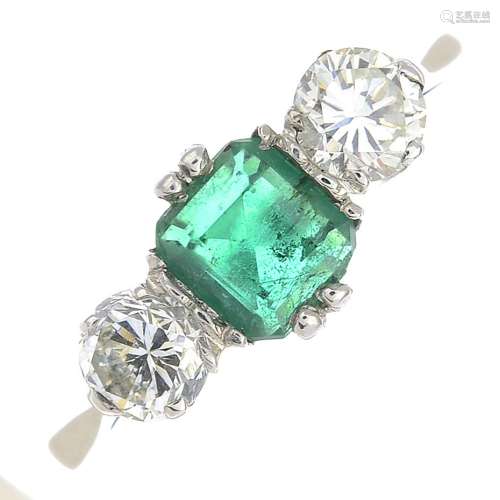 An emerald and diamond three-stone ring.Emerald weight 0.43ct.Estimated total diamond weight