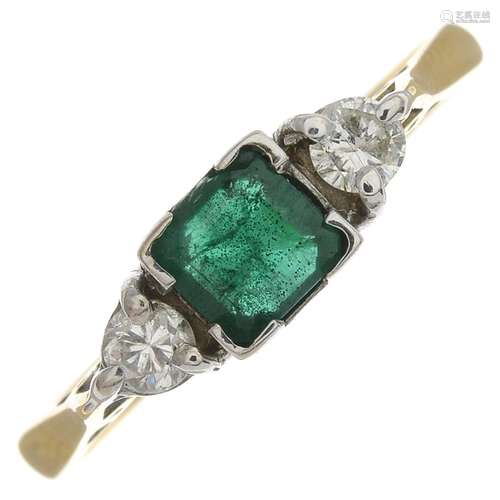 An 18ct gold emerald and diamond ring.Estimated total diamond weight 0.20ct,