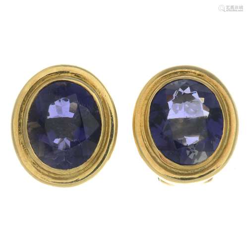 A pair of iolite single-stone earrings.Iolite calculated total weight 7.37cts,